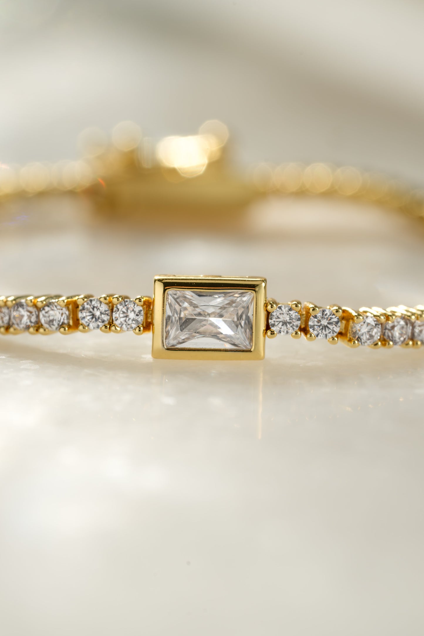 Bezeled Emerald-Cut Charm Tennis Bracelet